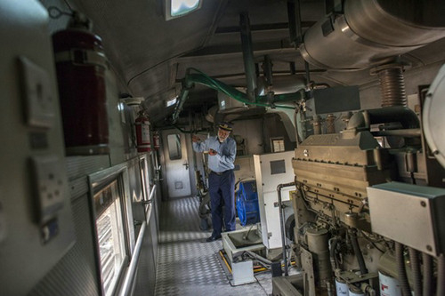 巴基斯坦引进的“绿线”列车内部，车组人员在发动机旁工作。（彭博新闻社网站）