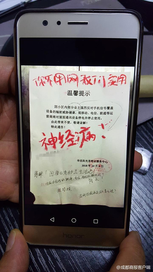 物业工作人员向记者展示张贴在小区内的通告。