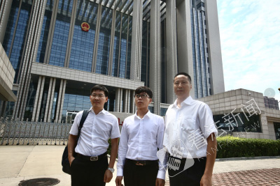 被判无罪后，廖海军（中）与律师走出法院。摄/记者 杨小嘉