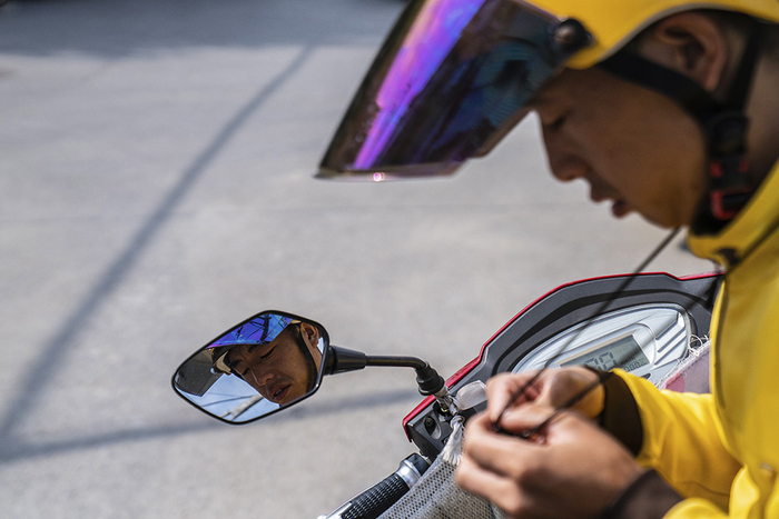 2019年9月17日，北京望京，李慧军在系紧头盔绳。