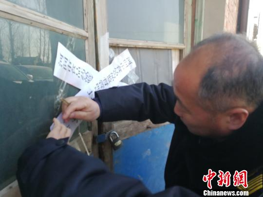 1月9日，河间市食品药品监督管理局执法人员给查处的黑作坊贴上封条。　李晓伟　摄