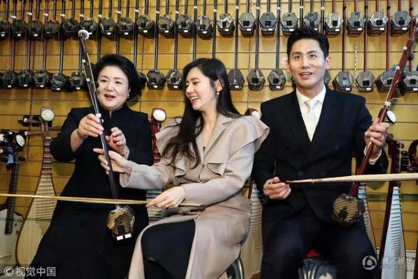 ▲13日下午，在北京新街口乐器一条街，韩国总统文在寅的夫人金正淑女士与中韩明星夫妇于晓光、秋瓷炫一同体验中国传统弦乐器二胡。