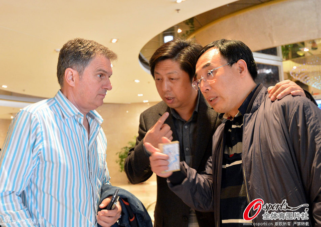 卓尔总经理陈旭东通过翻译与主教练图拔交流