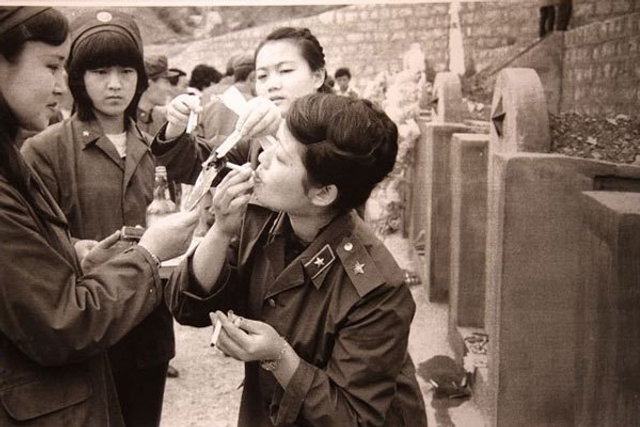 点燃香烟祭奠战友的女兵